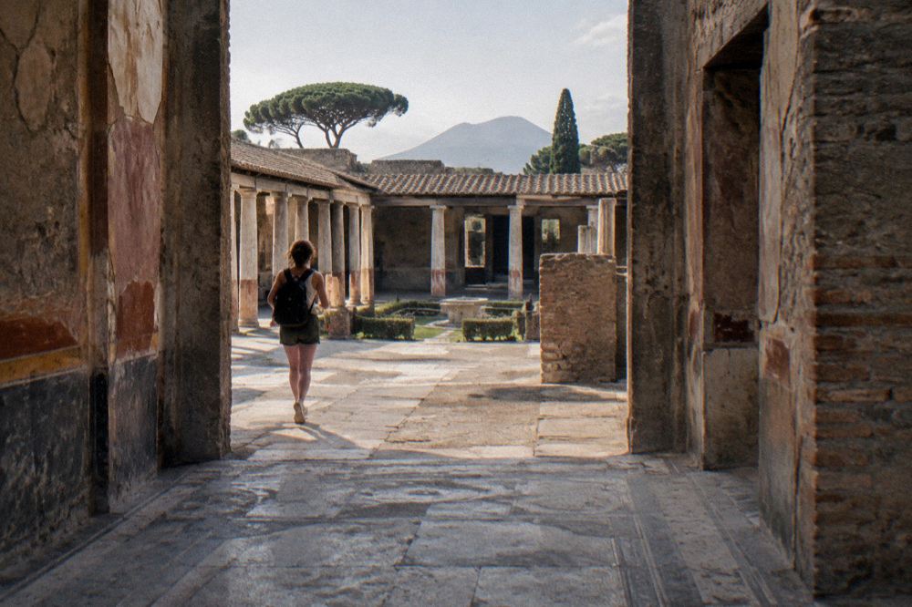Ancient Roman columns standing along a stone street under a clear sky