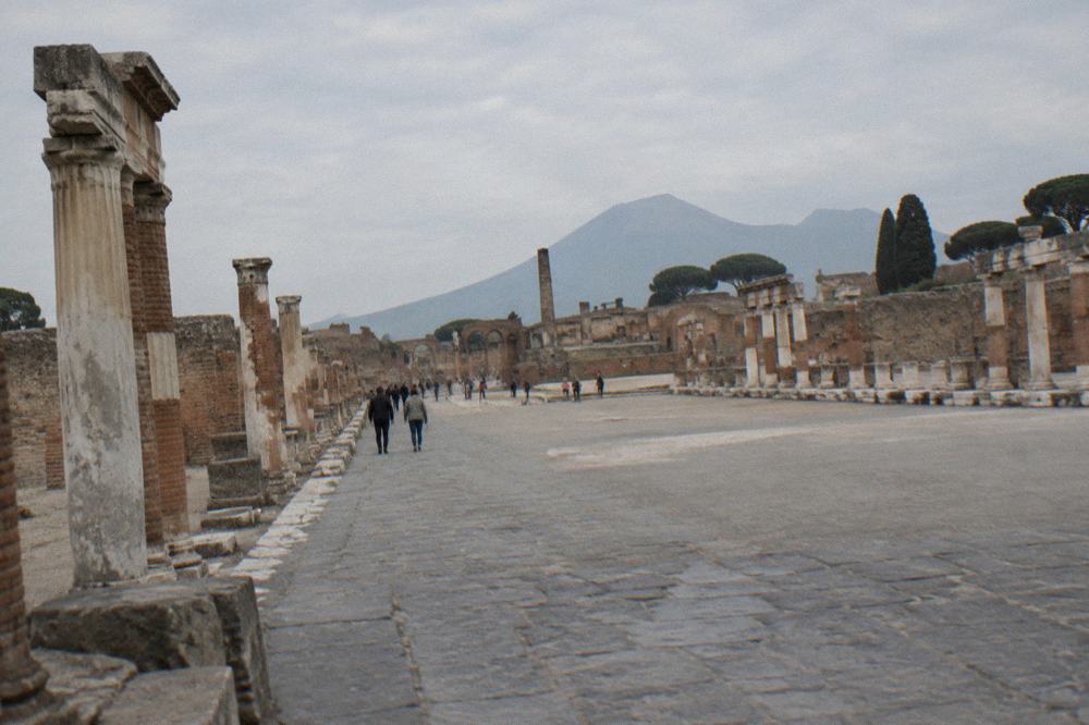A wide low-ceilinged gallery of ancient burial recesses cut into pale stone