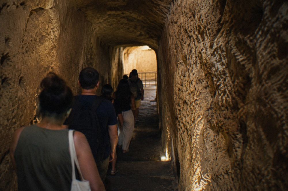 Ancient stone steps worn smooth leading down between high walls