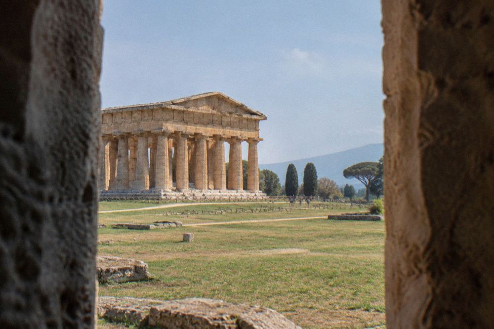 Close view of fluted stone columns of an ancient Doric temple against a clear sky