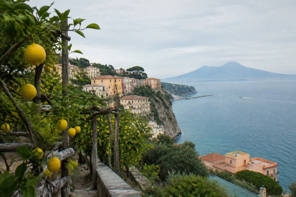 Cliffside pastel buildings above a small harbour on the Sorrento peninsula