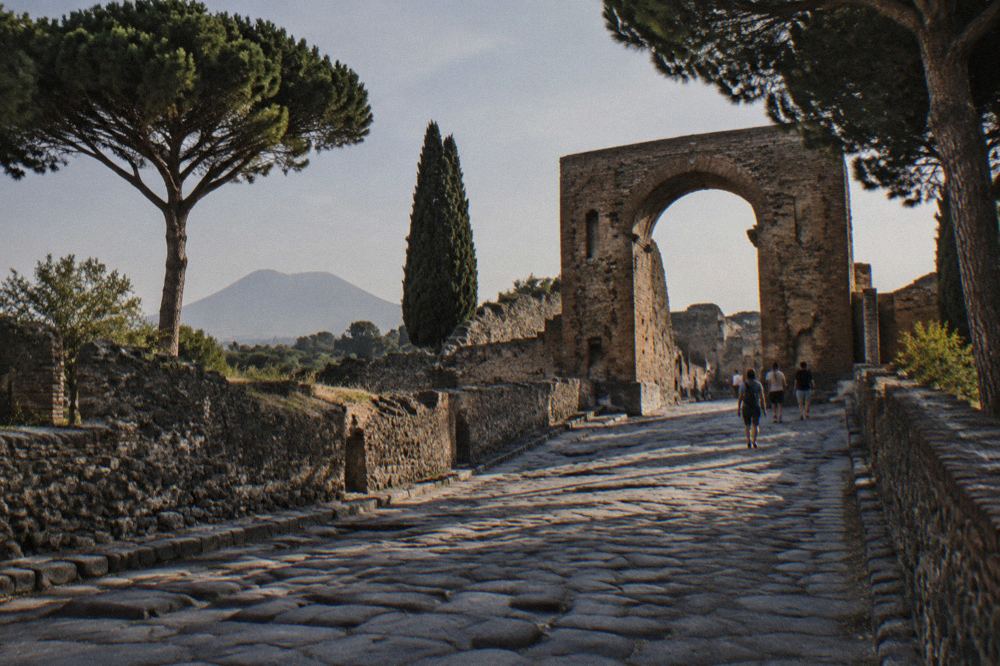 Long colonnaded walkway of a Roman villa opening onto a garden courtyard