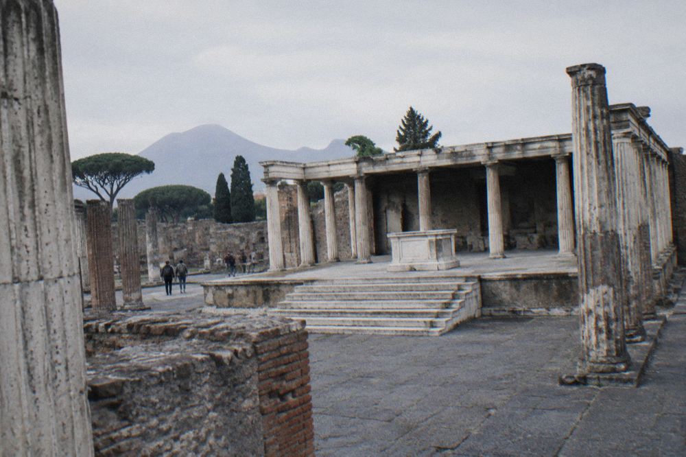 Ancient Pompeian gateway opening onto a stone road leading away from the ruins
