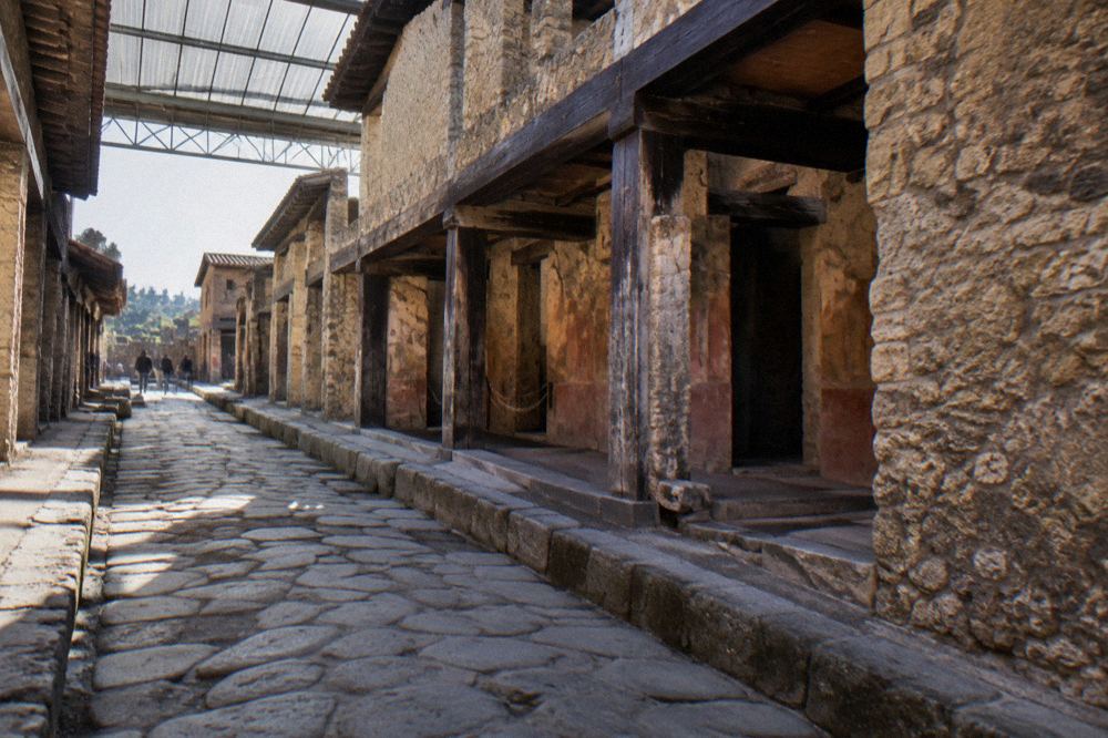 Weathered carbonised wooden doorframe preserved inside a stone doorway of an excavated Herculaneum house