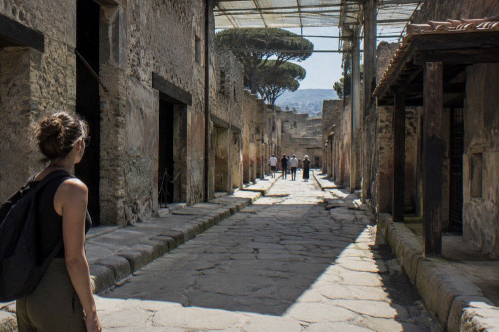 A well-preserved frescoed wall with deep red panels inside a Herculaneum house