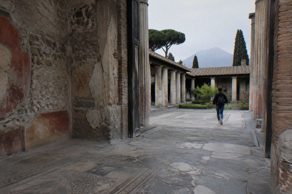 Plaster casts of Pompeii victims lying in an excavated garden enclosure