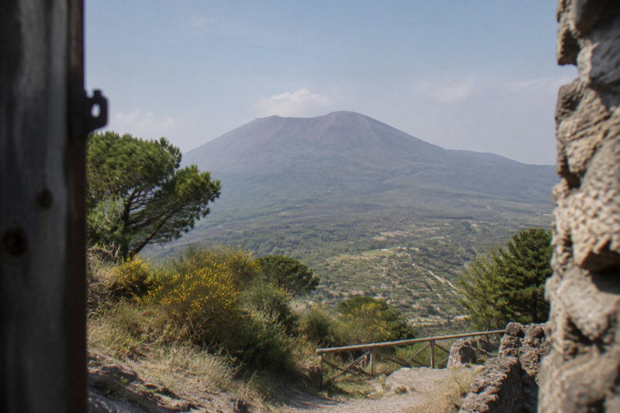 The crater rim of Mount Vesuvius under a clear sky above the Bay of Naples