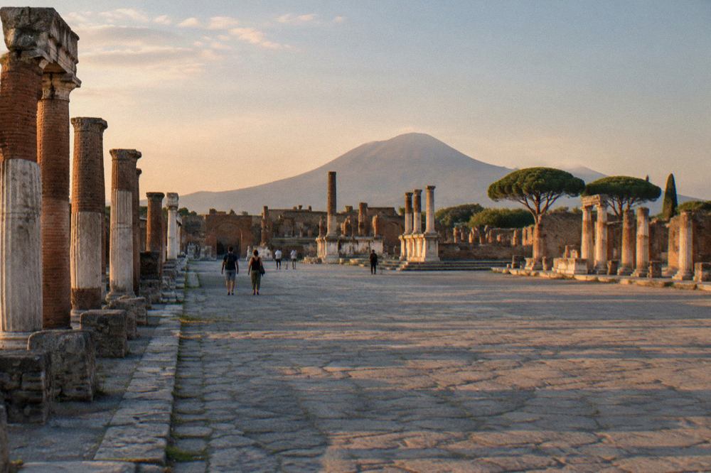 Ancient stone street in Pompeii with worn stepping stones and ruined walls under a clear sky