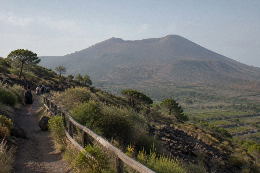 The Gran Cono crater of Mount Vesuvius seen from the trail, bare volcanic slopes rising to the rim