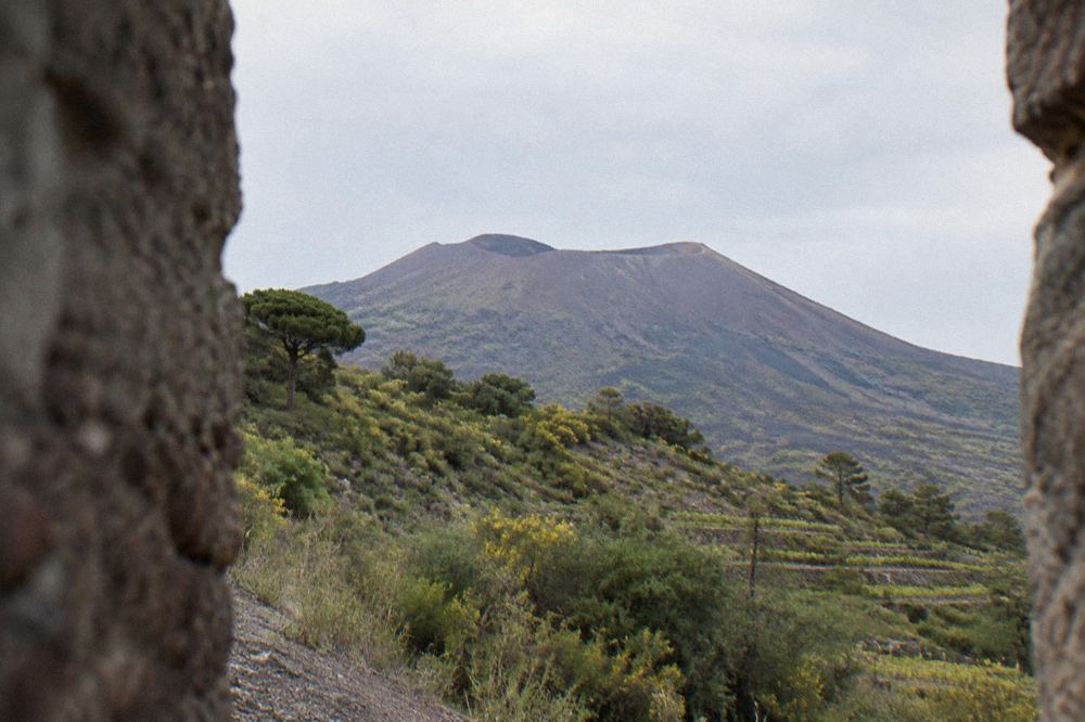Hikers gathered at a trailhead gate on Vesuvius waiting for a timed entry slot