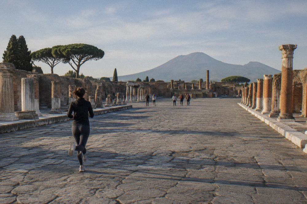 Early morning light over the Vesuvius trail with the Bay of Naples visible beyond the slopes