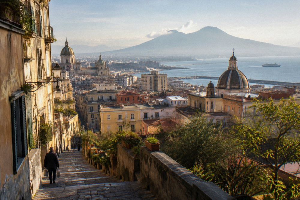 A cliff-top terrace in Sorrento overlooking the Bay of Naples with lemon trees and a view of Vesuvius