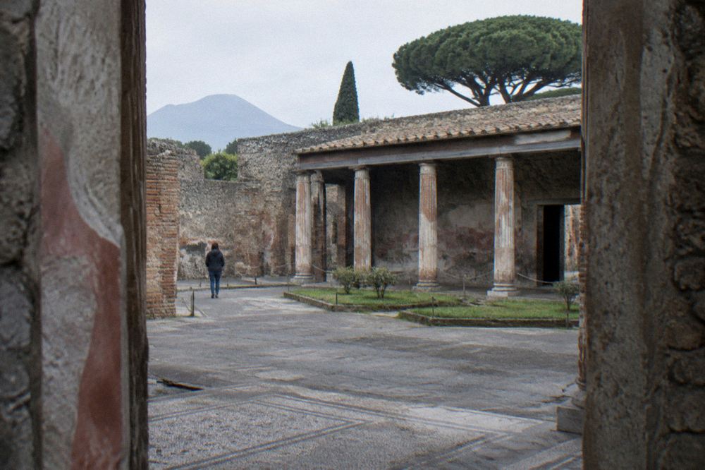 A quiet modern Italian town square with cafe tables near the Pompei sanctuary