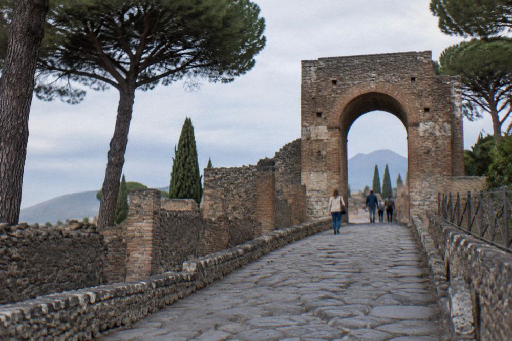 Roman stone street inside Pompeii with raised stepping stones and worn cart ruts