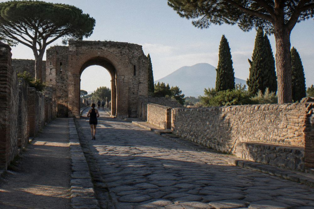 Colonnaded walkway of the great palaestra in Pompeii with plaster columns and grass interior