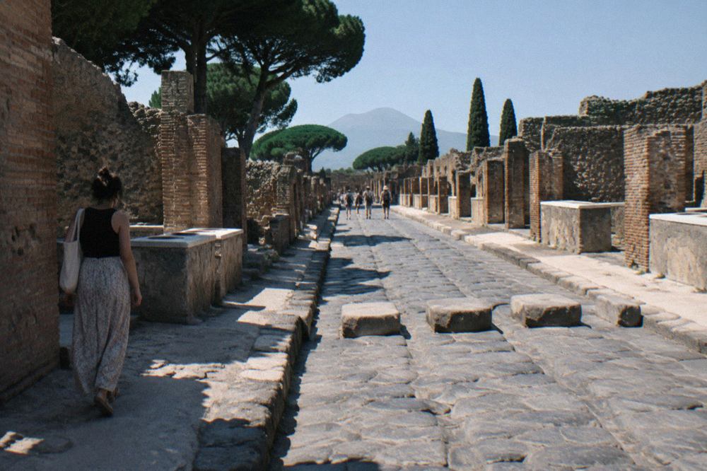 Ancient stone gateway of Pompeii with worn ruts in the paved Roman road