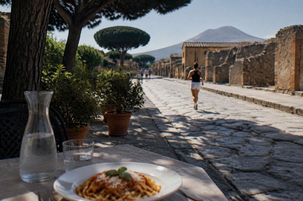Walking route through Pompeii's stone-paved ancient street with ruts worn by cart wheels