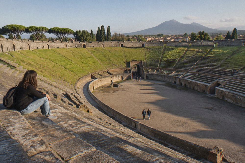 Rows of weathered stone seating inside the ancient amphitheatre at Pompeii