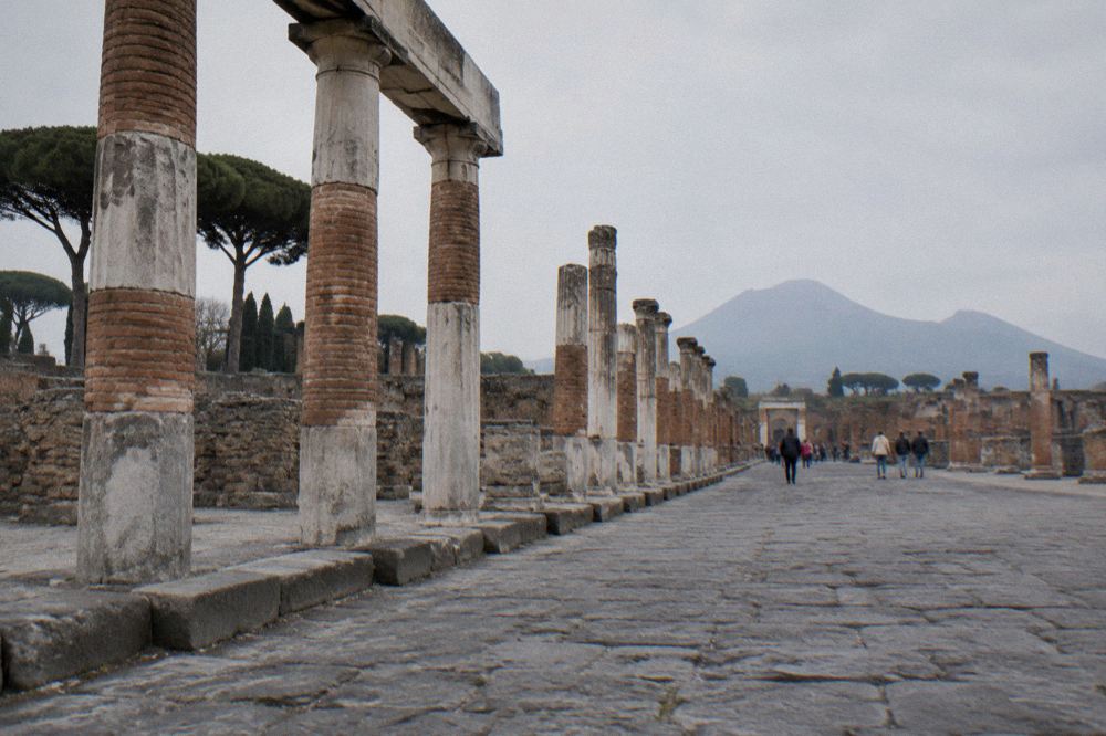 Open grassy area and ruined walls at the eastern edge of Pompeii near the amphitheatre