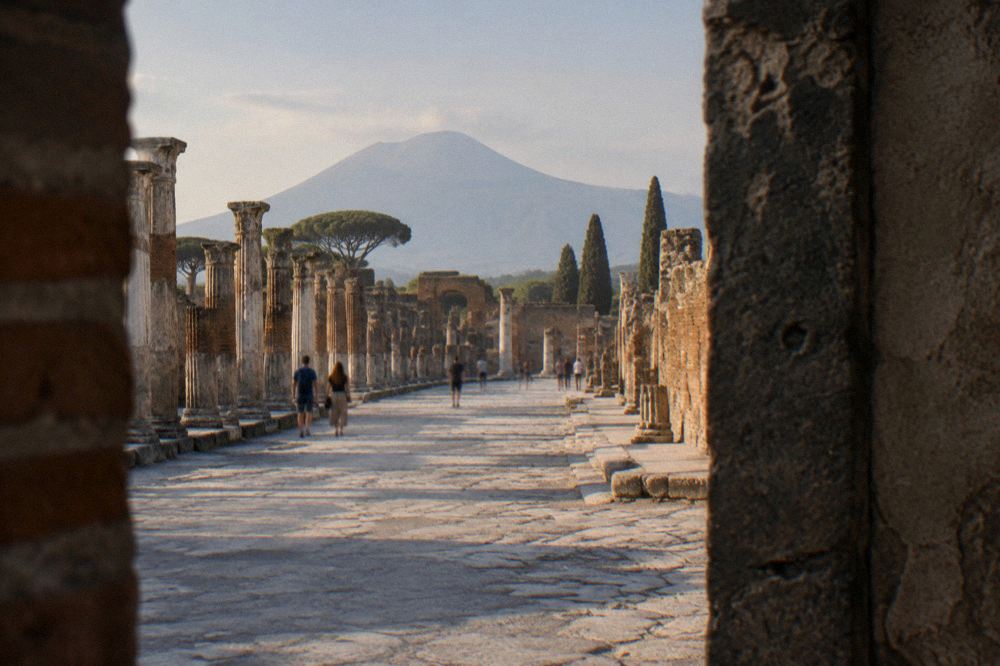 Evening light on the stone rim of the amphitheatre at Pompeii with the plain beyond