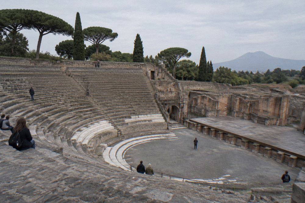 Ancient stucco wall in Pompeii with weathered inscriptions under open sky
