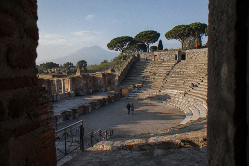 Sunlit Pompeii street with ancient walls and stepping stones