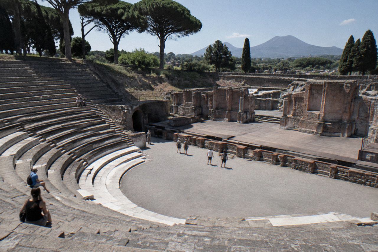 Ancient stucco wall in Pompeii with weathered inscriptions under open sky