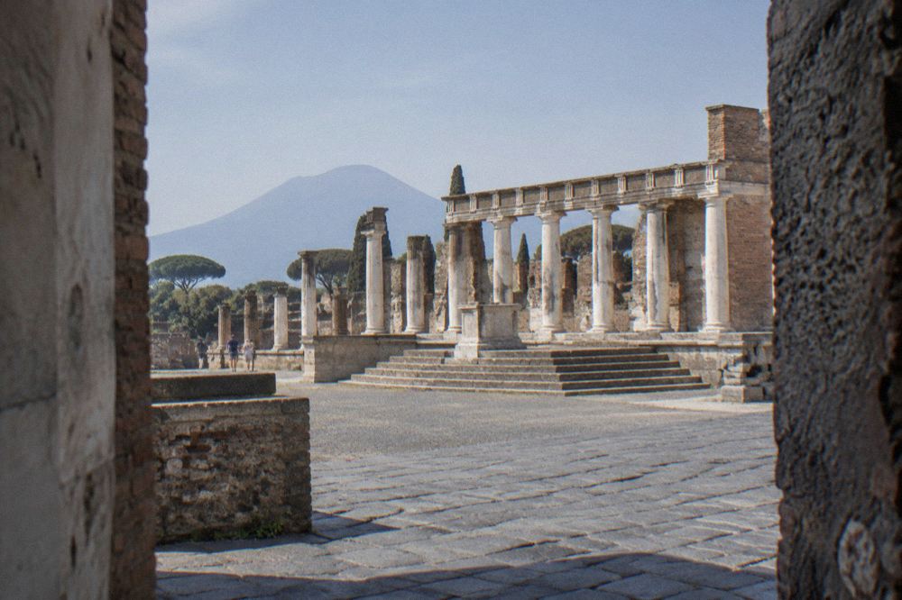 Row of stone columns standing along the edge of the ancient forum at Pompeii