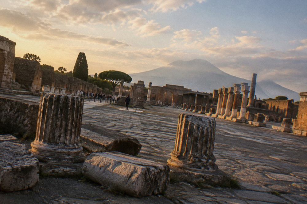 Ancient stone street in Pompeii with worn paving stones under open sky