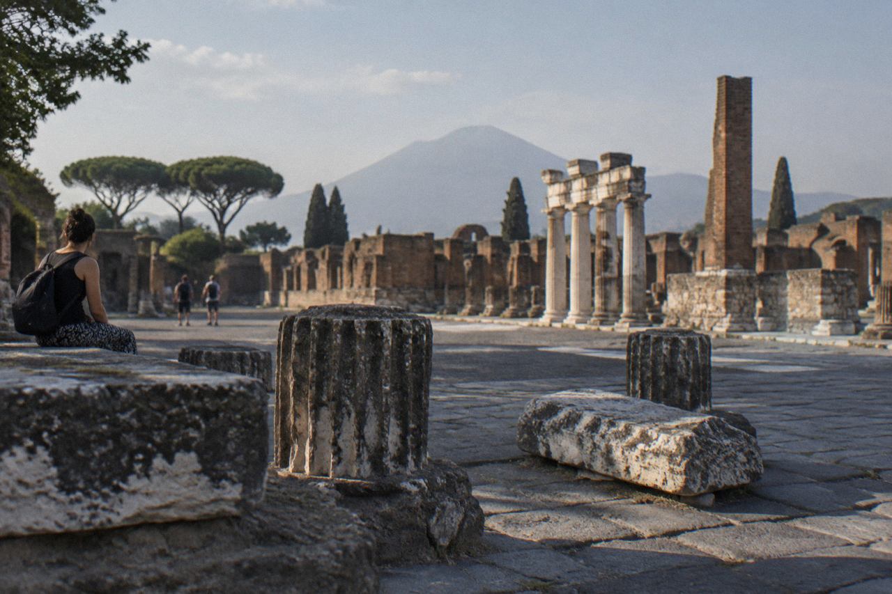 Ancient stone street in Pompeii with worn paving stones under open sky