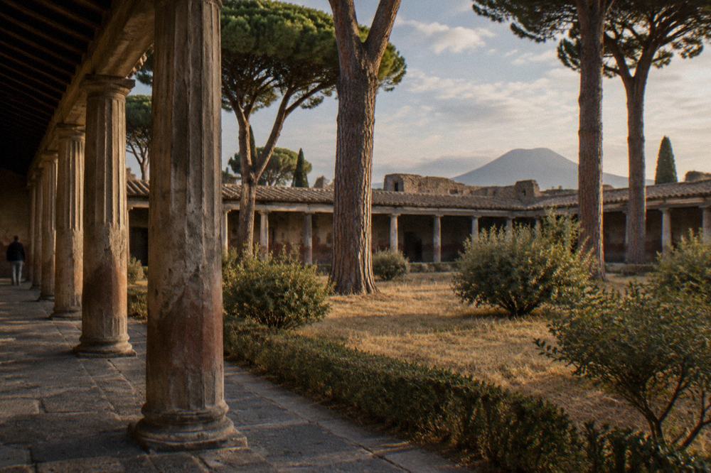 Faded painted wall of an excavated Pompeii building under protective cover