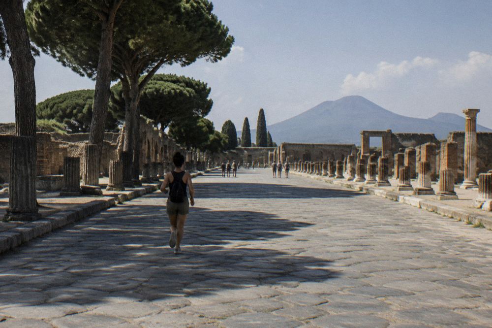 Guide speaking to a small group beside ancient Pompeii ruins