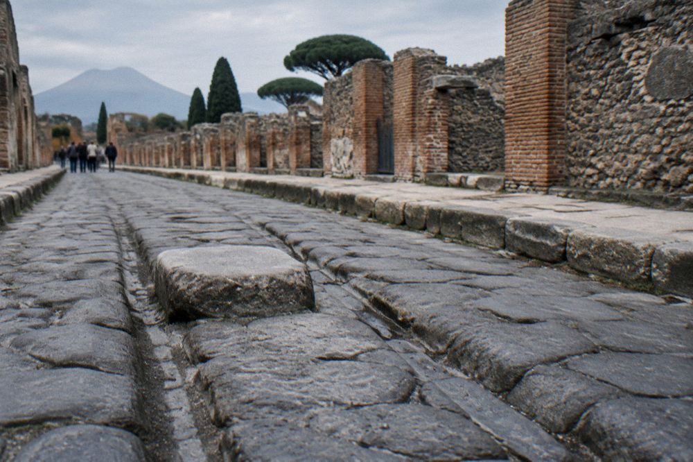 Open guidebook resting on a stone bench beside Pompeii ruins