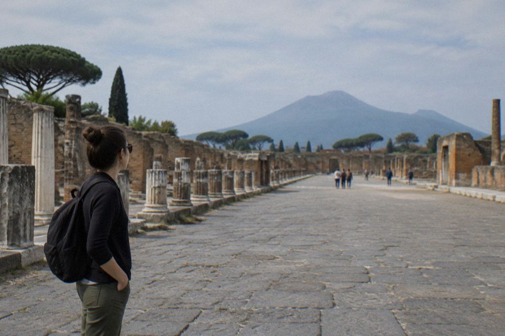 Long shadows across the columns of the Pompeii forum in late afternoon light