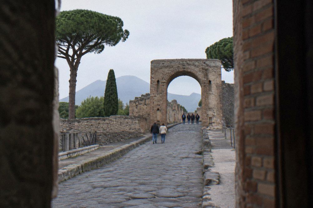 Wide view over the excavated ruins of Pompeii toward Vesuvius in morning light