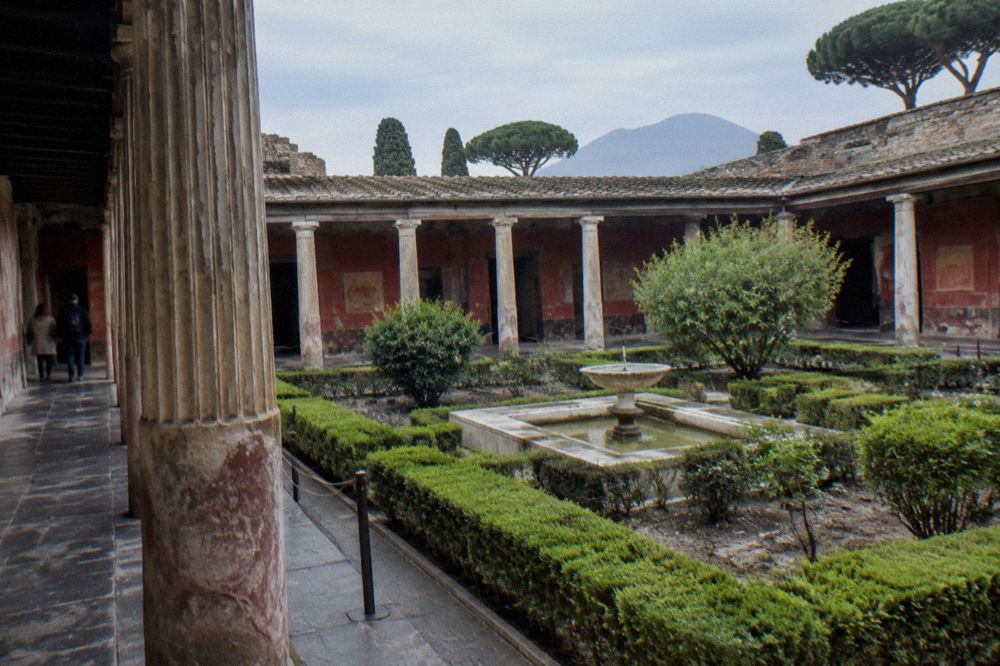 Ticket office area at a Pompeii entrance with visitors queuing in late morning