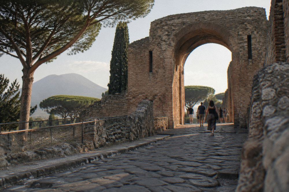 Sunlit colonnade along a Pompeii street at midday