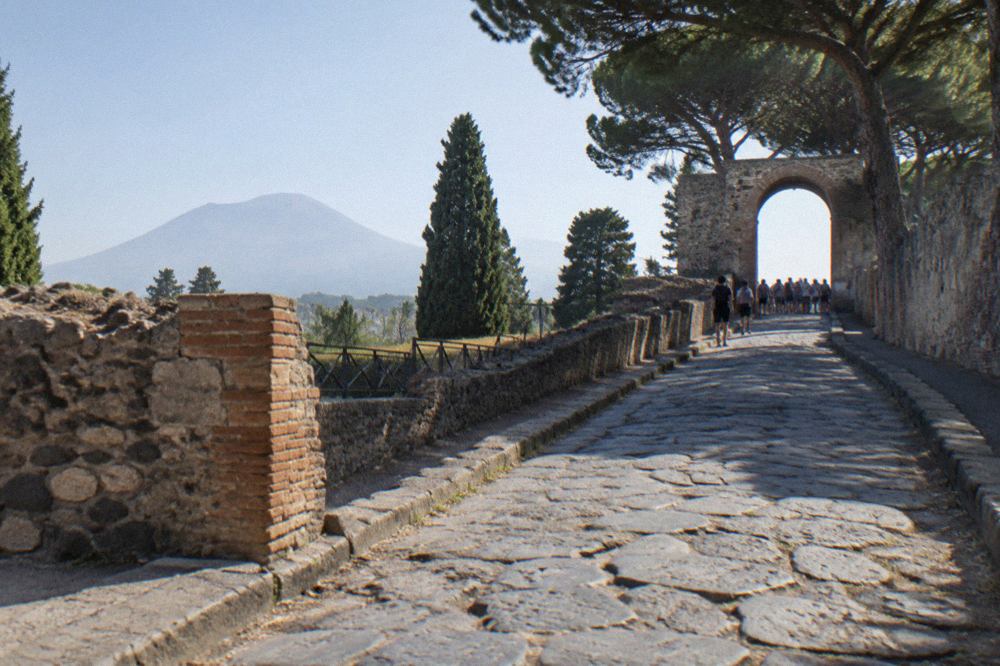 A quiet street in the modern town of Pompei with stone buildings under a clear sky