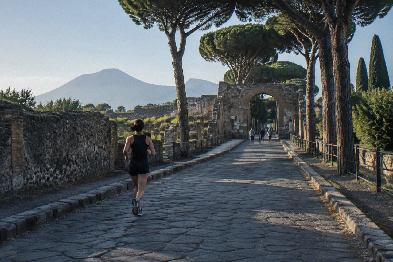 A quiet street in the modern town of Pompei with stone buildings under a clear sky