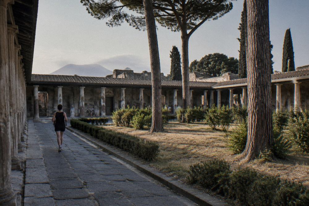 Roman amphitheatre seating rows curving under open sky at Pompeii