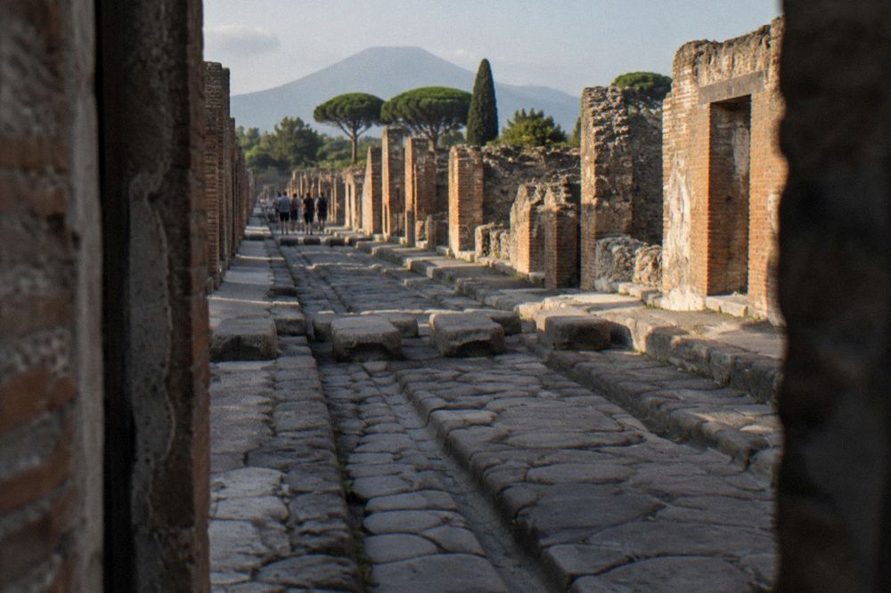 Golden evening light across Pompeii ruins with long shadows on ancient walls