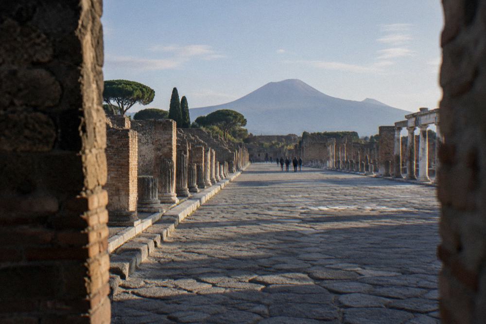 The excavated ruins of Herculaneum with modern apartment buildings of Ercolano visible behind the site