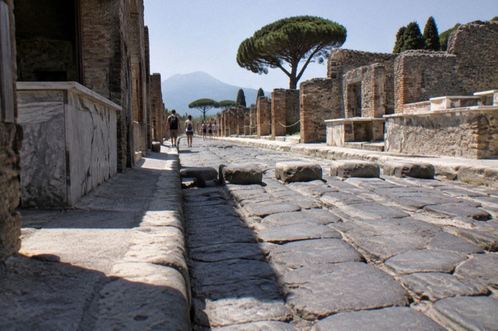 The Porta Marina entrance to Pompeii with visitors queuing at the ticket office and the ruins visible through the gate