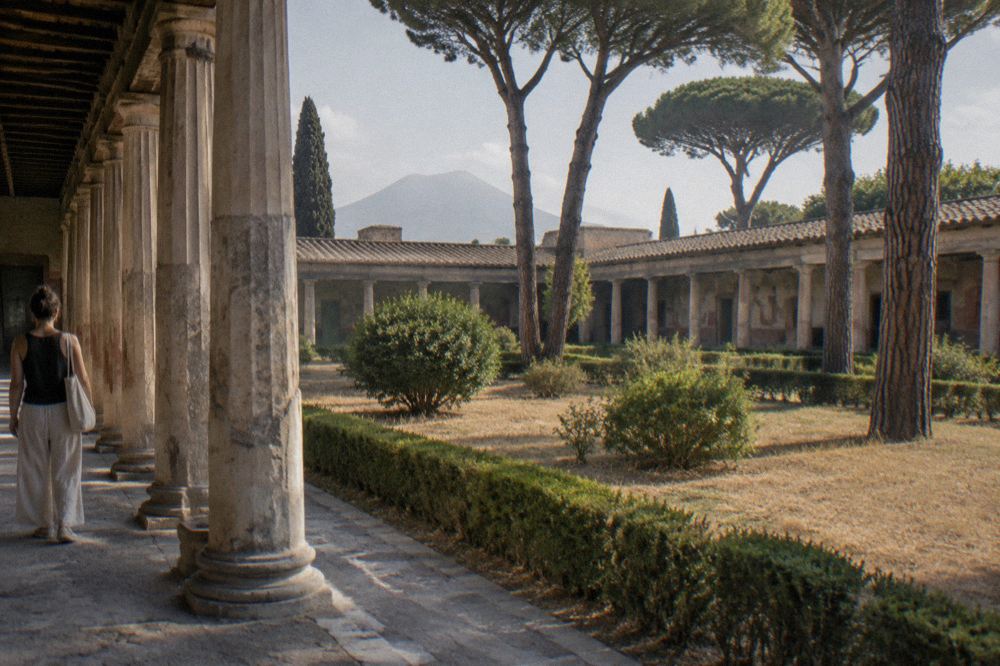 Ticket office windows at an entrance to the Pompeii archaeological park with visitors waiting outside