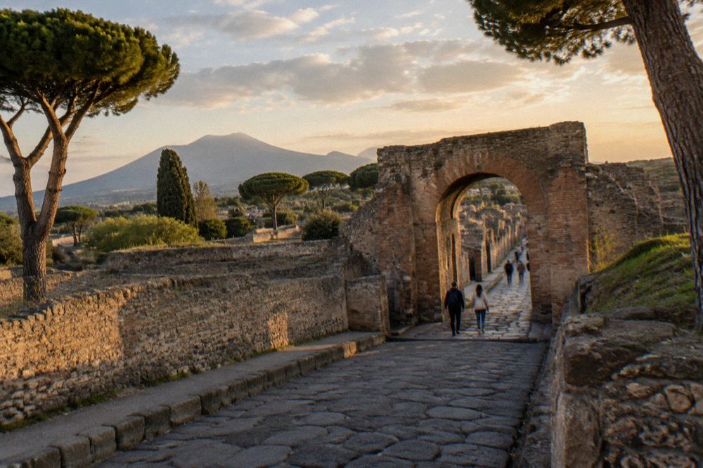 Turnstiles and staffed gate at the Porta Marina entrance to Pompeii with the ancient walls behind