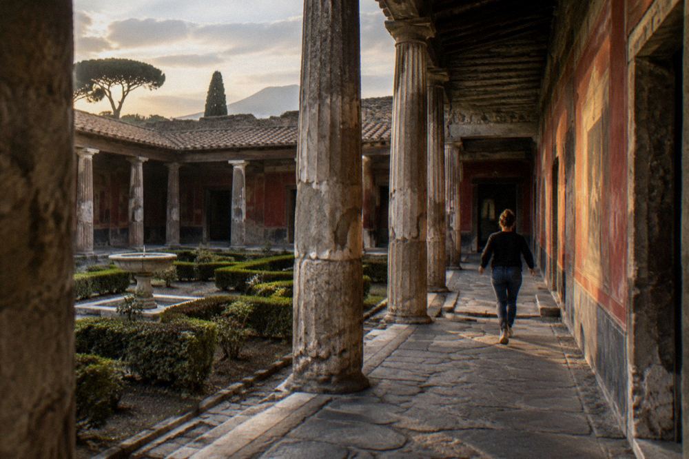 Stepping stones crossing an ancient paved street in Pompeii, with worn stone surfaces and wheel ruts