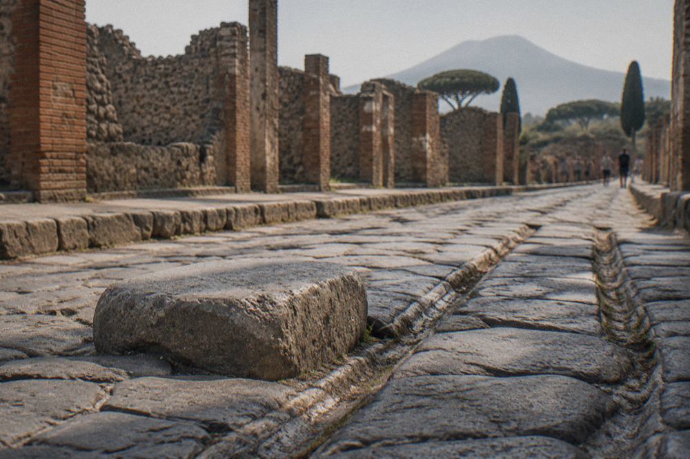 Ticket office area at a Pompeii entrance with ancient stone archway