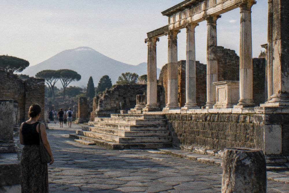 The ancient walls of Pompeii seen from outside the Porta Marina entrance in warm light