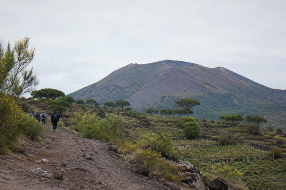The crater of Mount Vesuvius under a pale sky above the Bay of Naples