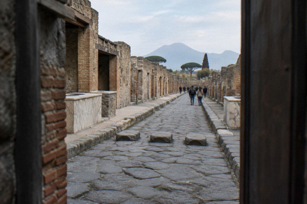 A narrow street in the Naples old town with worn stone buildings and hanging laundry